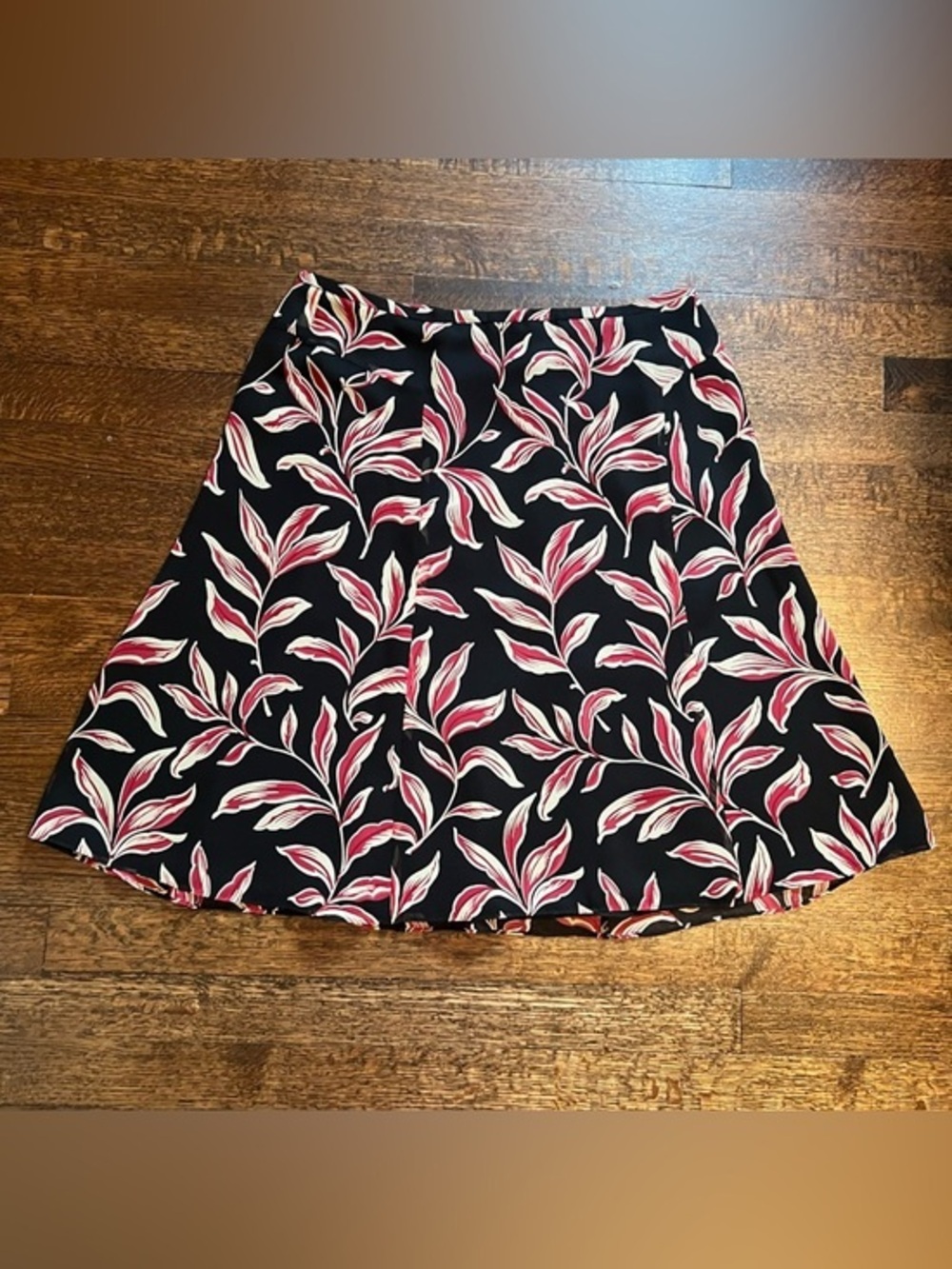 Ann Taylor black with leaf print A line above knee silk skirt. Size 12.